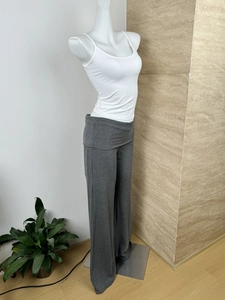 Detailed side view of grey high-waisted flared knit trousers with soft cotton texture