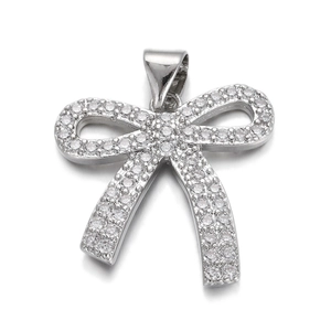 Detailed macro view of a silver butterfly charm pendant featuring full diamond inlay