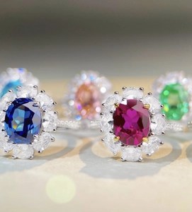 Macro detail of 925 sterling silver rings with colorful ruby and emerald gemstones
