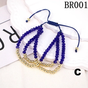 Detail view of blue faceted beads and gold metal spacers on adjustable woven bracelets