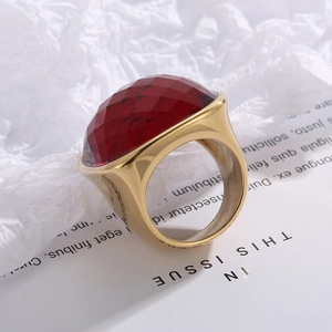 Detail of red faceted crystal cocktail ring with wide gold stainless steel band