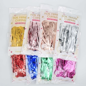 Variety of colorful foil fringe curtains in packaging for party wall decoration