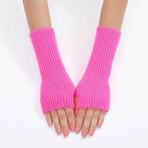 Detailed view of bright pink ribbed knit fingerless gloves on a model's hands