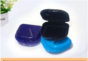 Three durable plastic orthodontic retainer cases in dark blue, black, and light blue colors
