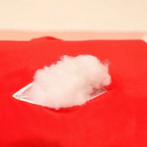 Detail view of the hidden zipper and soft white cotton filling on the plush pillow