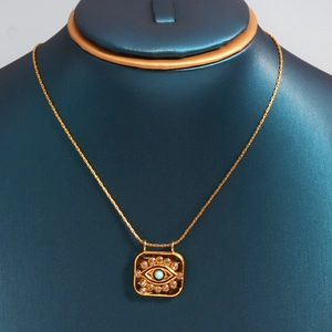 Detailed close-up of a square evil eye pendant with turquoise stone and inlaid diamonds