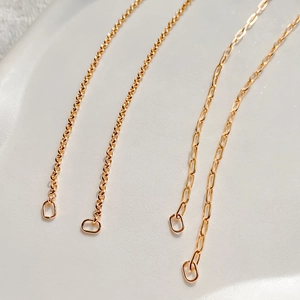 Detailed macro view of square and paperclip gold plated stainless steel DIY chain links