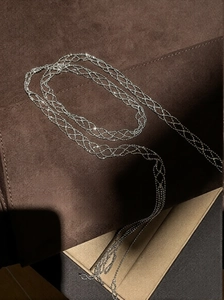 Detailed macro view of the silver multi-layer mesh braided necklace on a velvet jewelry tray