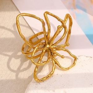 Artistic close-up of a 18K gold-plated floral ring with layered wire petals on stone