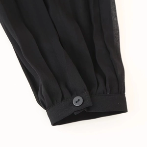 Women's black chiffon dress with pleated buttoned cuffs and commuter style detailing