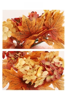 Detailed view of autumn wreath with orange maple leaves and silk flowers for Thanksgiving