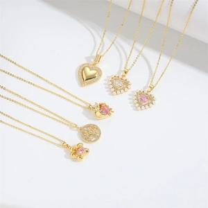 Elegant gold pendant necklace set with heart charms, pearls, and pink crystals on white background