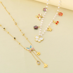 Detail of floral butterfly pendants with pearls and colorful enamel on gold chains