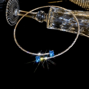 Detail of silver irregular choker with blue zircon stones and sparkling crystals