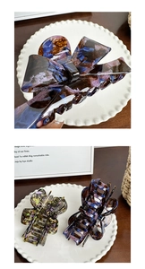Detail of purple and blue marble pattern acetate bow hair claw clip with firm grip