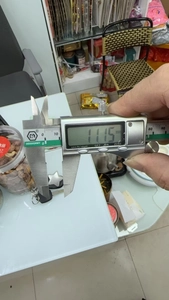 Detail showing precise measurement of a star-shaped jewelry charm using a digital caliper