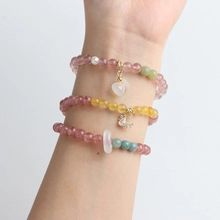 Close-up of three-piece natural stone bead bracelets with heart and moon charms