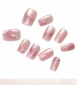 Macro detail of pink cat eye press-on nails with mermaid shimmer and 3D wave texture