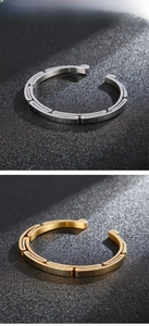 Detail of silver and gold stainless steel bracelets with chain texture and matte finish
