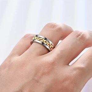 Detail of bicolor fidget spinner ring in gold and silver finish worn on finger