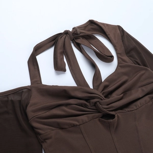Detail of twisted knot neckline and shoulder cut-out on brown knit long sleeve top