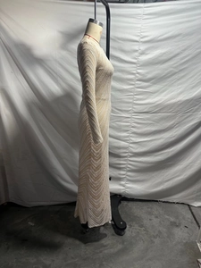 Detail shot of champagne sequin dress with wavy bead patterns and slim fit profile
