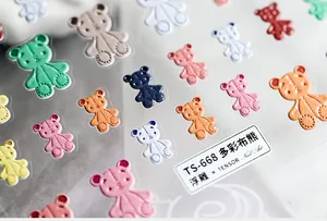 Macro view of 3D embossed colorful teddy bear nail art stickers with fabric texture