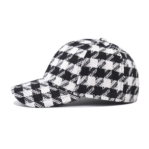 Close-up of thick black and white houndstooth wool fabric on a baseball cap