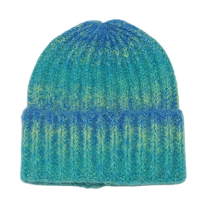 Close-up of tie-dye knit beanie in blue and yellow showing thick ribbed wool texture