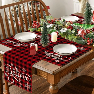 Close-up of red and black buffalo plaid Christmas placemat with white Believe script