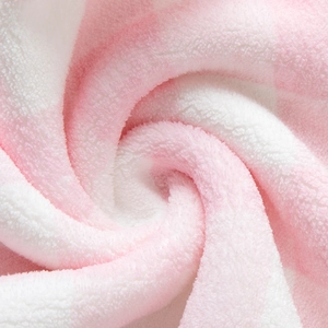 Macro detail of soft pink and white coral fleece fabric with fluffy plush texture