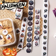 Close-up of colorful Halloween round stickers with pumpkin and skull on gift boxes