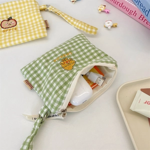 Close-up of cute checkered fabric organizers for earphones and small accessories