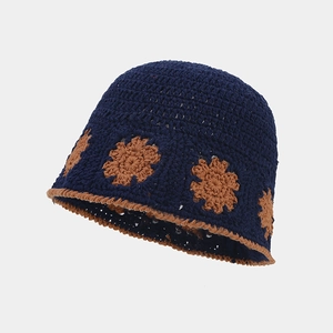 Detailed view of hand-crocheted hollow flower patterns on this navy blue bucket hat