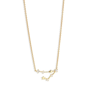 Detailed macro view of gold constellation pendant with sparkling cubic zirconia stones