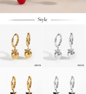 Detailed view of red apple earrings in gold and silver finish with colorful gemstones