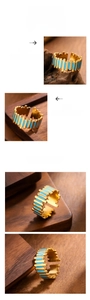 Macro shot of 18k gold vintage ring with light blue enamel and gear-shaped edge