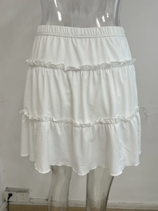 Detail view of white three-layer tiered skirt with elastic waist and ruffle design