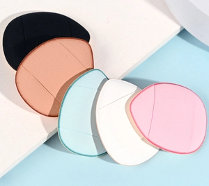 Close-up of five colorful mini finger powder puffs in a stackable layout