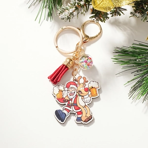 Close-up of Christmas keychain with Santa, reindeer, sequin ball and red tassel detail