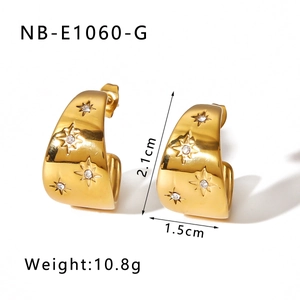 Detailed view of U-shaped gold plated earrings with star patterns and zircon crystals