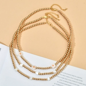 Three-piece gold beaded necklaces with daisy, heart, and star charms for women