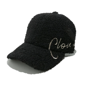 Detail of Cloud embroidery on black sherpa baseball cap with fuzzy wool texture