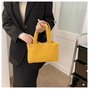 Detail showing plush yellow teddy fabric and soft texture of the trendy handbag