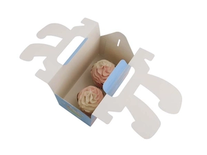 Detail of Easter bunny treat box with handle showing two cupcakes inside the blue holder