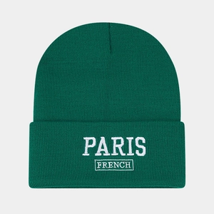 Close-up of fine knit texture and white Paris embroidery on a dark green beanie