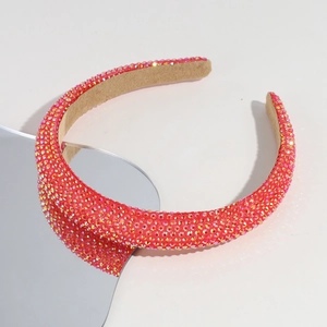Close-up of a wide Baroque headband featuring dense red rhinestones and non-slip lining