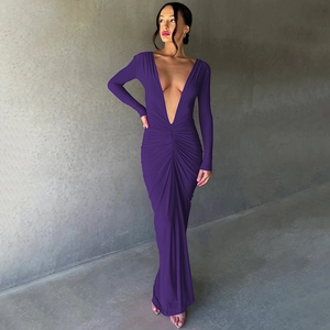 Detail of the elegant deep V-neckline and ruched waist on a long purple dress
