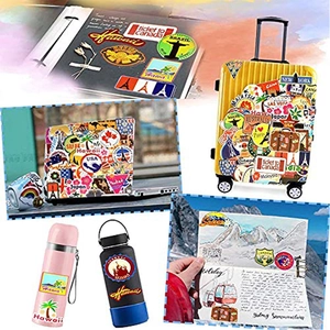 Detail of waterproof travel stickers on suitcases, laptops and water bottles showing world landmarks