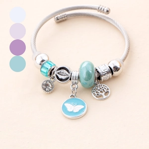 Silver plated stainless steel charm bracelet with blue butterfly and tree of life pendants